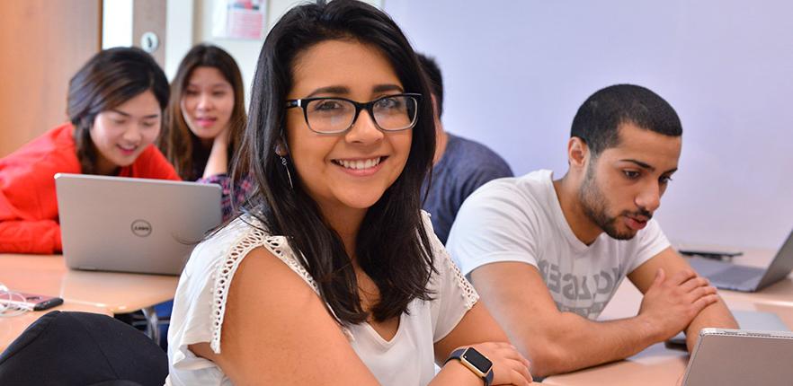 HEBSBA undergraduate student smiling in class